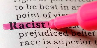 "Racist" highlighted in pink marker in a book.