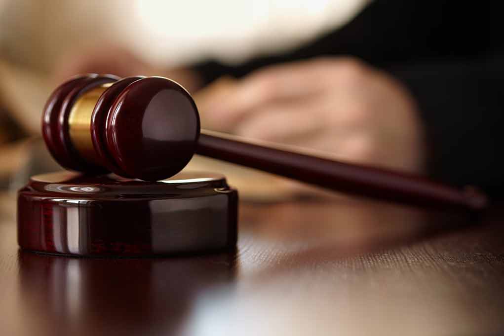 Gavel resting on a wooden sound block