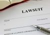 Lawsuit document with pen and open book