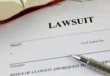 Lawsuit document with pen and open book