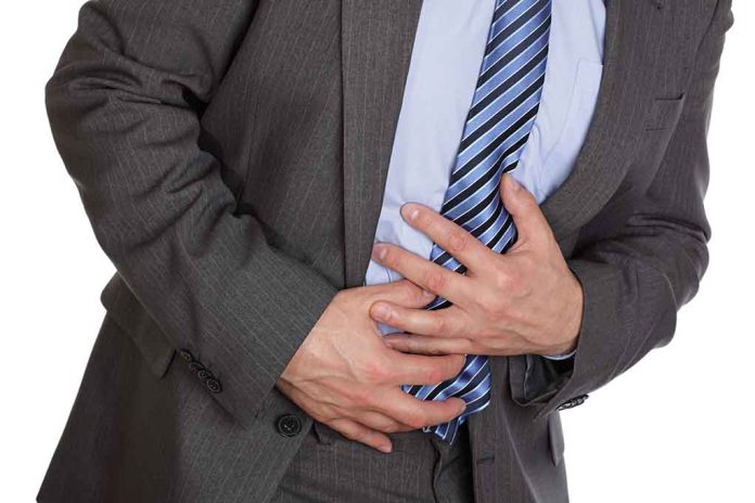 101302762 featured image Man clutching stomach in pain wearing a suit