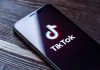 Phone screen showing TikTok logo and app