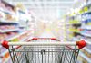 Shopping cart in aisle of grocery store