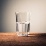 Glass of water on wooden surface