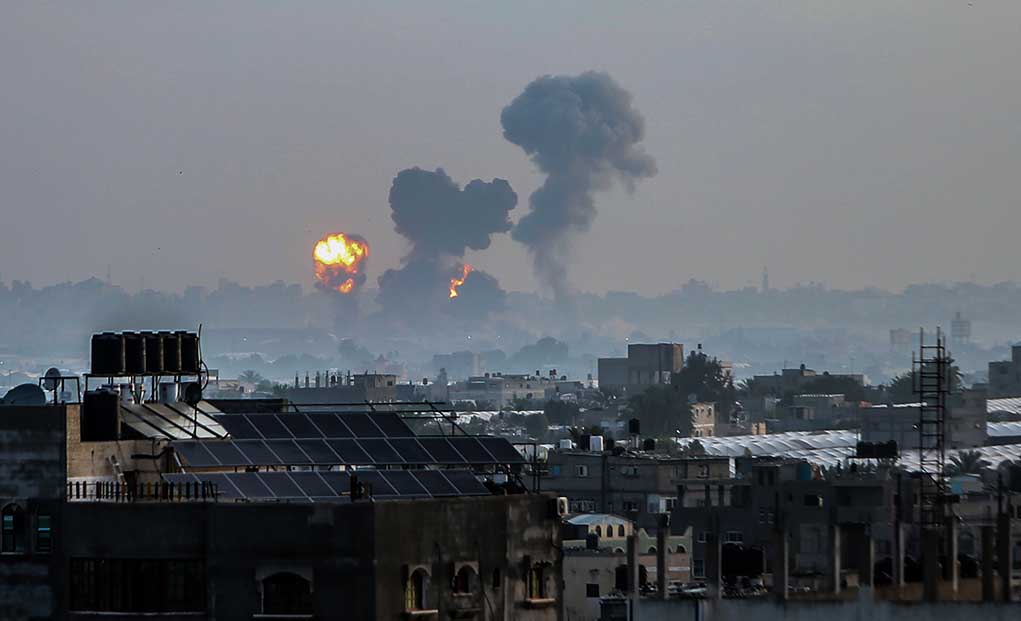Flames and smoke billowing over a cityscape
