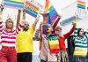 Diverse group at pride march with rainbow flags