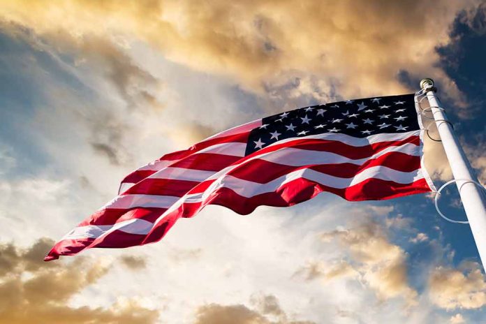 360951227 featured image American flag waving against a cloudy sky