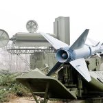 Military missile launcher with radar systems in a foggy field