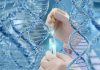 Hands with pipette and test tube surrounded by DNA strands