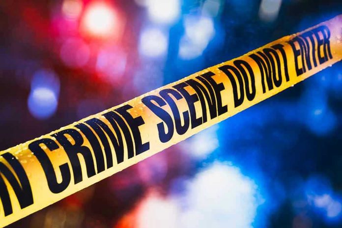 1019775253 Yellow crime scene tape with blurred lights background