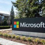 Microsoft sign with office buildings and trees