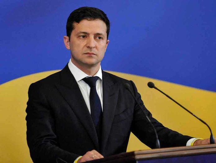 Man in suit speaking at podium with microphones