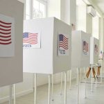 Voting booths with American flag and VOTE Signs