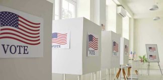 Voting booths with American flag and VOTE Signs
