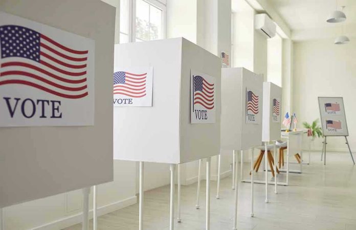 2367560637 Voting booths with American flag and VOTE Signs