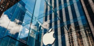 Apple store with glass facade and city reflections