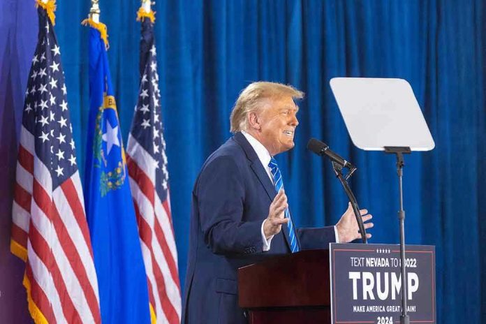 2427935455 Person speaking at podium with flags in background