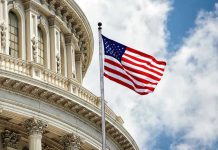 US flag in front of Capitol building dome