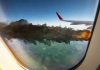 Airplane wing with engine on fire mid flight