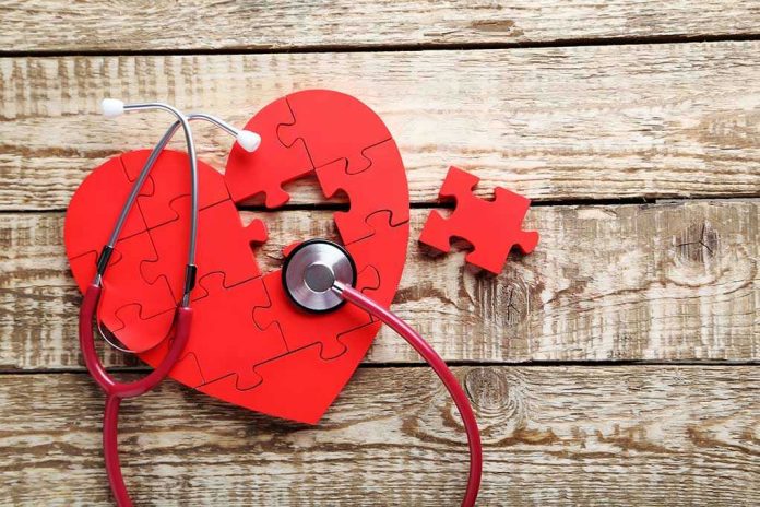 538329796 Red heart puzzle with stethoscope on wooden background.