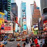 Times Square crowded with people and bright electronic advertisements