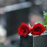 Two red roses on a gravestone
