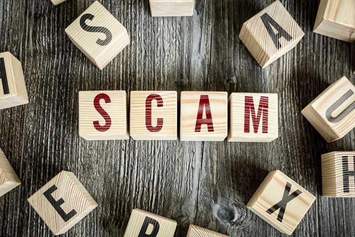 343236656 Wooden blocks spell SCAM on a rustic surface.