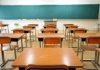 Empty classroom with desks and a chalkboard