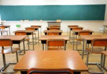 Empty classroom with desks and a chalkboard