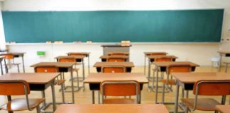 Empty classroom with desks and a chalkboard