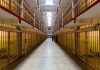Long hallway with prison cells on both sides