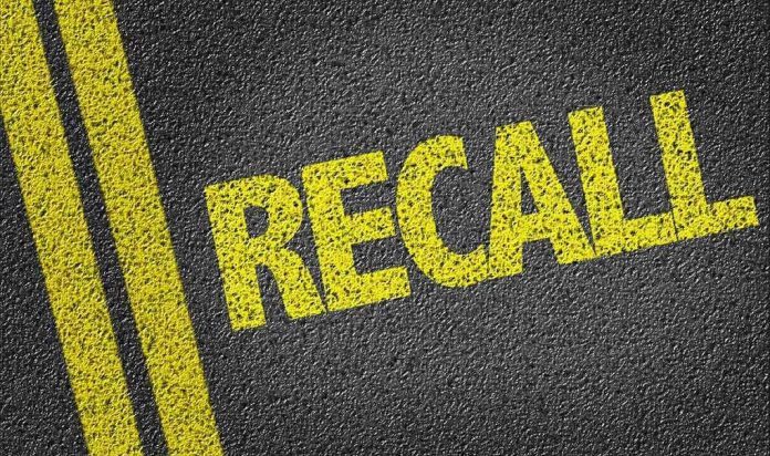 486784426 Yellow RECALL text on asphalt background.