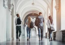 Four students walking in a corridor together
