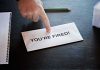 Envelope with YOURE FIRED! and pointing finger.