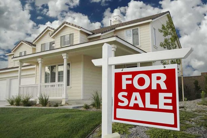 shutterstock_21431701.jpg A suburban house with a For Sale sign in the front yard