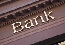 Close up of a bank sign with gold lettering