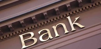 Close up of a bank sign with gold lettering
