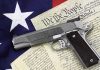 Gun on U.S. Constitution and flag
