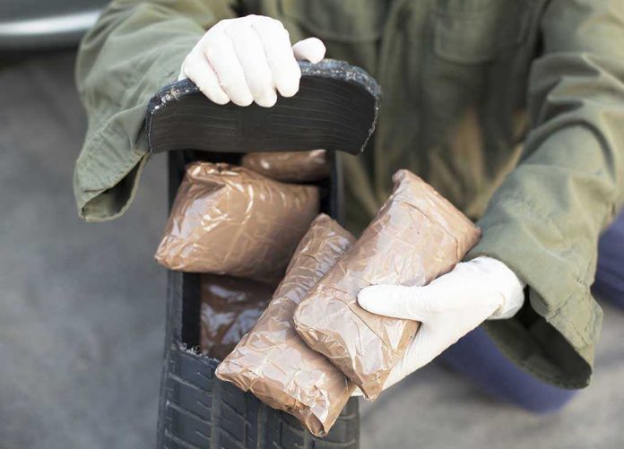 160035851 Person handling packages wearing gloves and green jacket