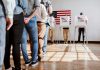 People in line at voting booths