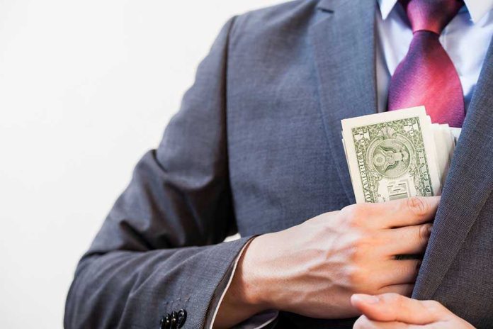 Person in suit putting money in jacket pocket