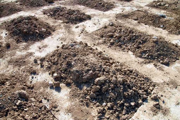 shutterstock_144786475.jpg Mounds of dirt arranged in rows on a construction site