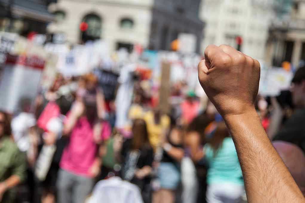Raised fist in front of a crowd