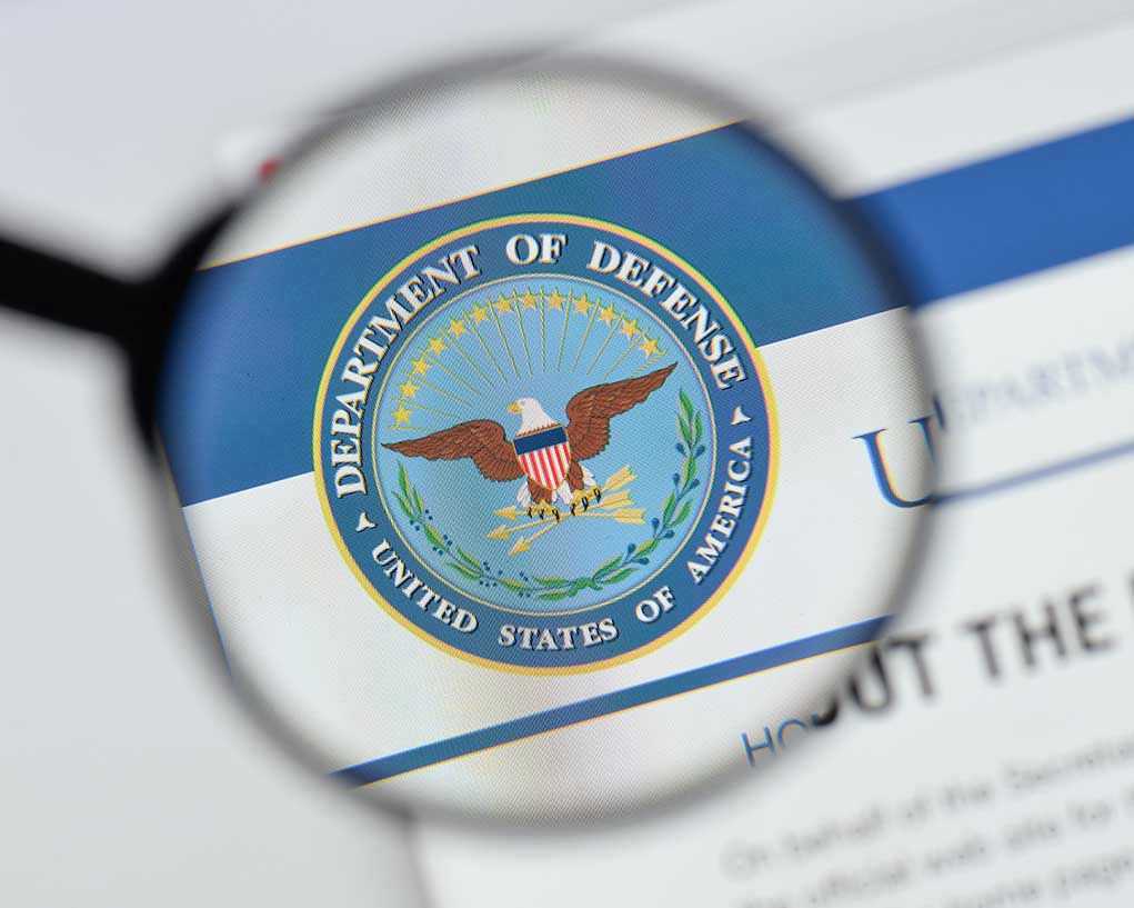 Magnifying glass over Department of Defense logo