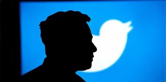 Silhouette of person against blue Twitter logo background