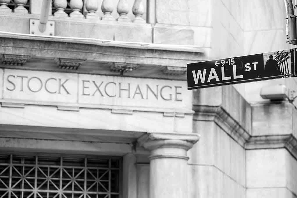 Stock Exchange building and Wall Street sign
