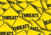 CHILLING Threats Target Trump Insider Yellow warning signs with the word THREATS