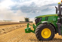 A green tractor in a wheat field