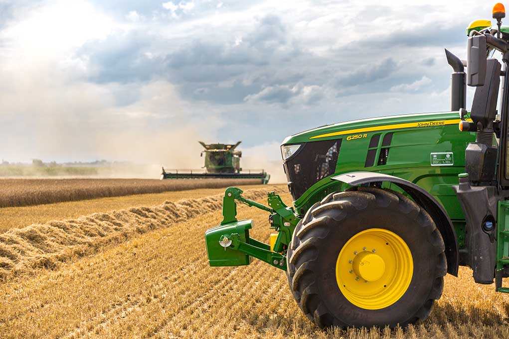 A green tractor in a wheat field
