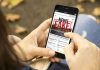 Person reading FAKE NEWS on smartphone